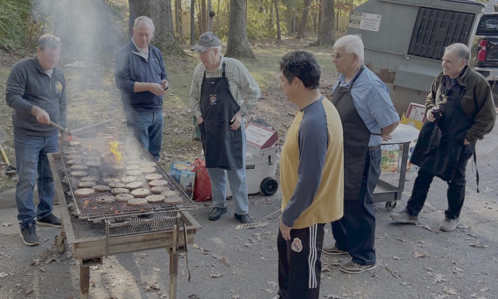 Knights grilling hamburgers for the Shelter residents